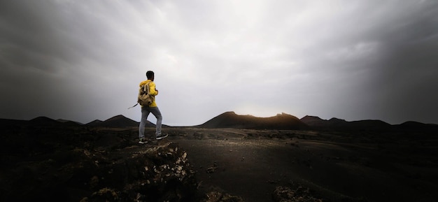 Man on top of mountain Epic shot of adventure hiking in mountains alone outside