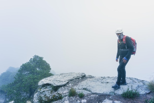 Man of the top of the mountain in the fog