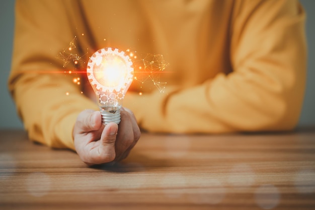 Man touching a bright light bulb Ideas for presenting new ideas inspiration in the work.