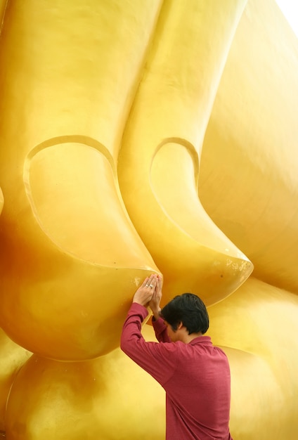 Man Touching Finger of Great Buddha Image for Blessing, Wat Muang Temple, Ang Thong, Thailand