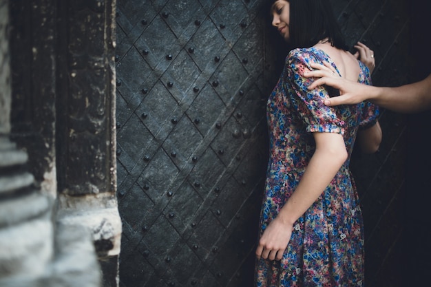 Man touching his back to a woman