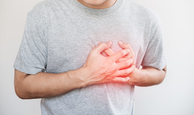 a man touching his heart, with red highlight of heart attack, and others heart disease concept