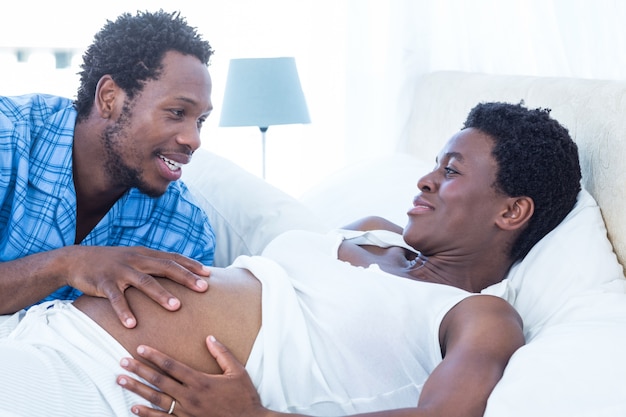 Man touching pregnant woman tummy 