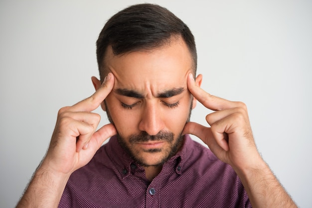 Man Touching Temples and Thinking Hard