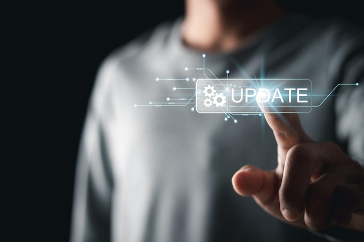 Photo man touching update button on virtual interface software updates or operating system upgrades to keep your device up to date with enhanced functionality in new versions and improved security