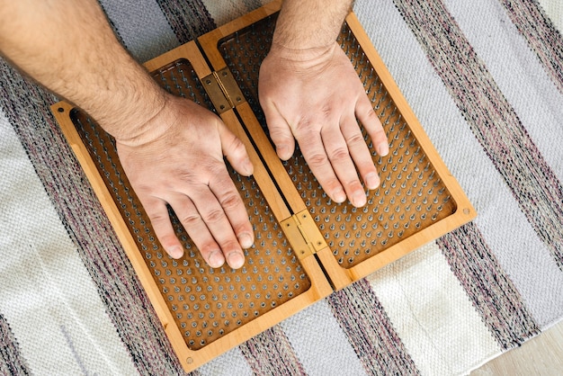 Man touching yoga wooden sadhu board