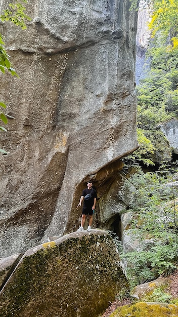 Foto un turista che fa un'escursione sulle rocce della foresta