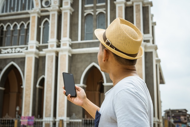 man tourist hold mobile for take photo or selfie himself