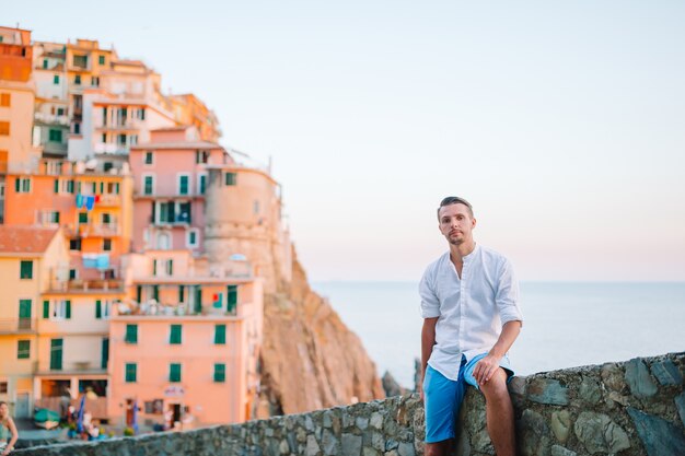 Man tourist outdoors in italian village on vacation