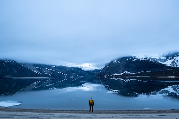 Man tourist with standing of great mountain Scandinavia nature