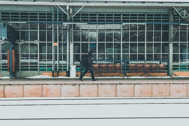 Man on the train station platform in winter