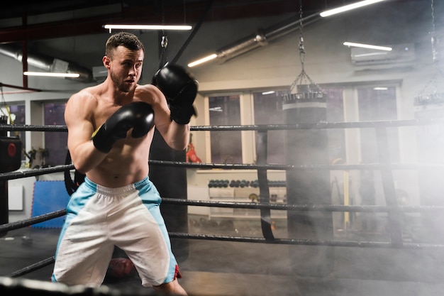 Man training in boxing ring