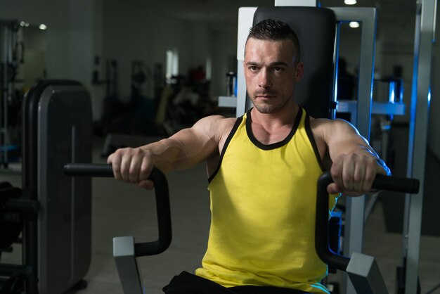 Man Training Chest Exercises On A Machine