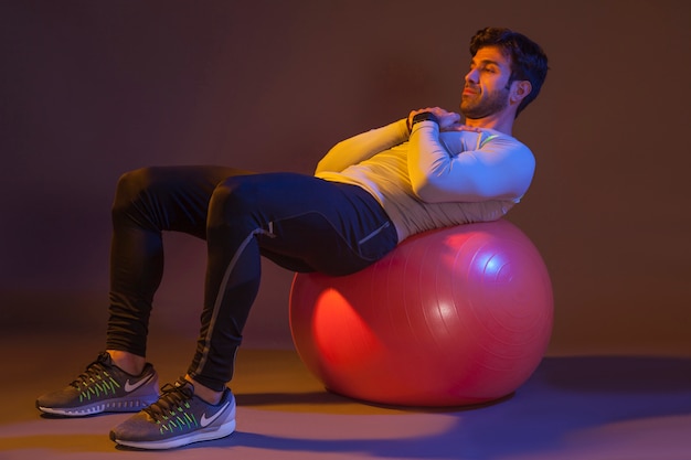 Man training on fitness ball