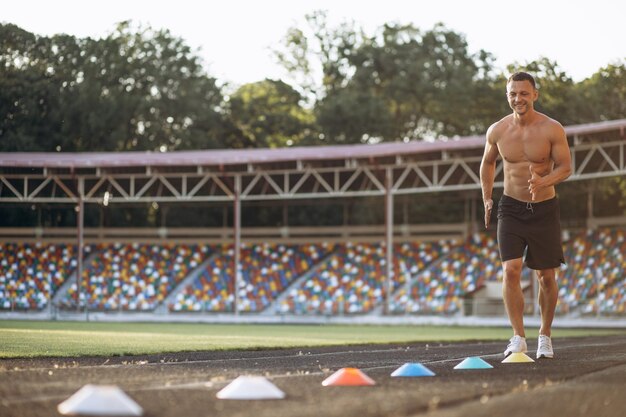 Man training using barriers at the stadium