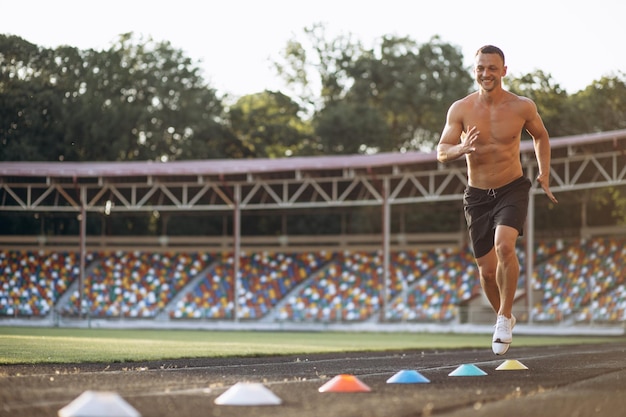 Man training using barriers at the stadium