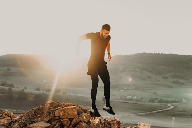 a man trains on a mountain in the early morning