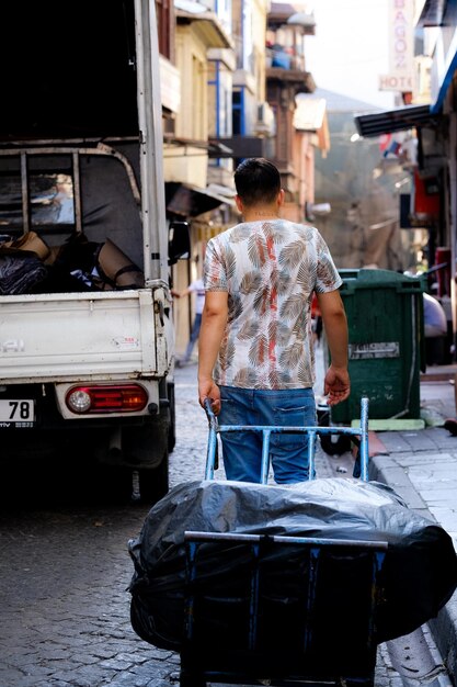 Photo man transporting trash stock photo