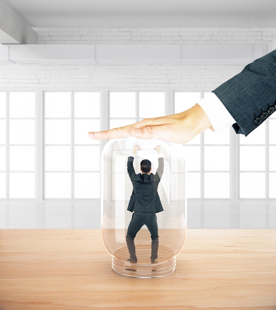 Photo man trapped inside jar by hand