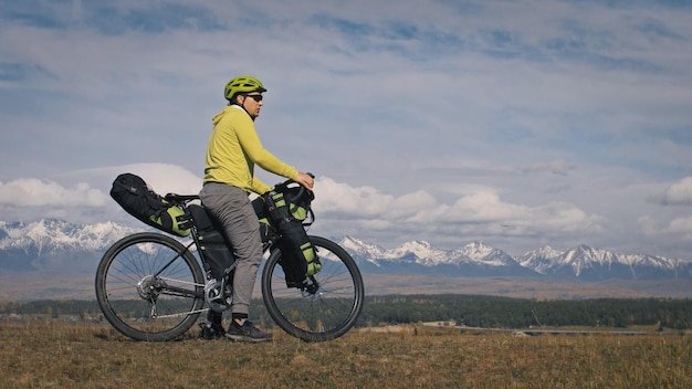 The man travel on mixed terrain cycle touring with bikepacking
