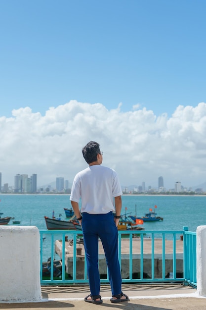 Man traveler visiting at Son Tra marina Tourist with blue dress and hat traveling in Da Nang city Vietnam and Southeast Asia travel concept