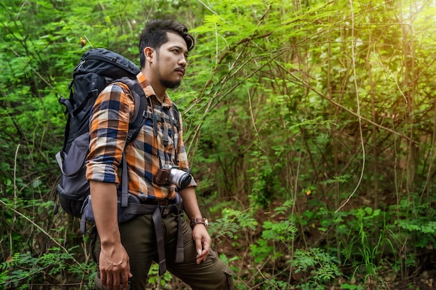 Man traveler with backpack in the forest