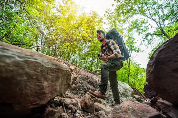 Man traveler with backpack in the forest