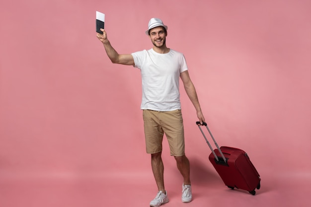 Man traveler with suitcase, passport and ticket.