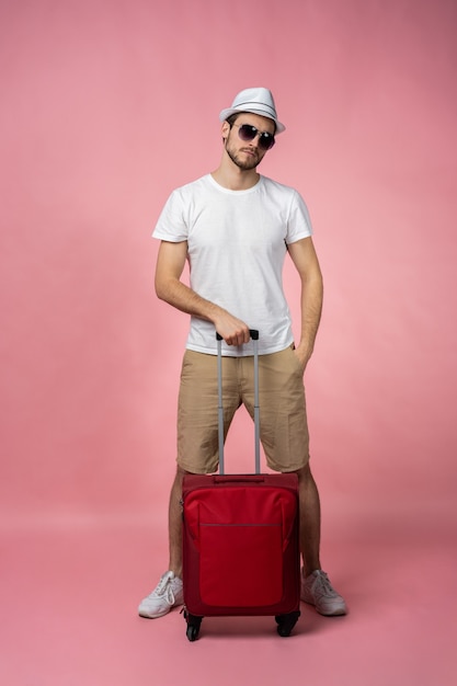 Man traveler with suitcase, passport and ticket.