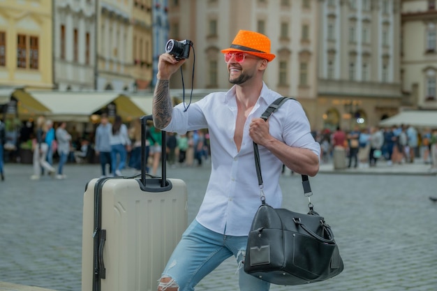 Man traveller with sunglasses hat and camera traveler man tourist traveling abroad to travel on week