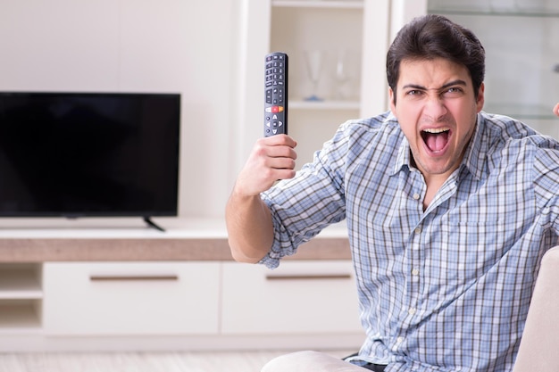 Man trying to fix broken tv