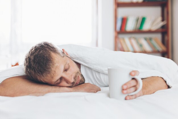 Foto uomo che cerca di svegliarsi la mattina