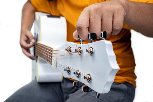 Man tuning guitar string