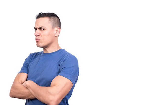 Man turning aside with arms crossed and a doubtful expression