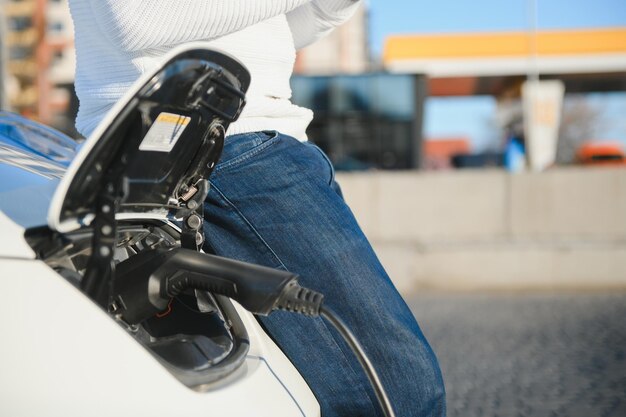 Man turning on charging of car