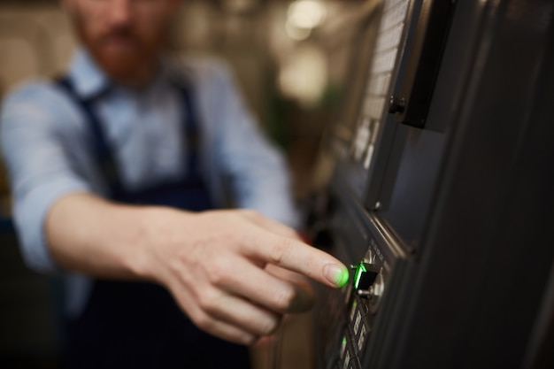 Man turning on the machine