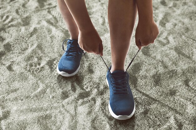 Man tying running shoes