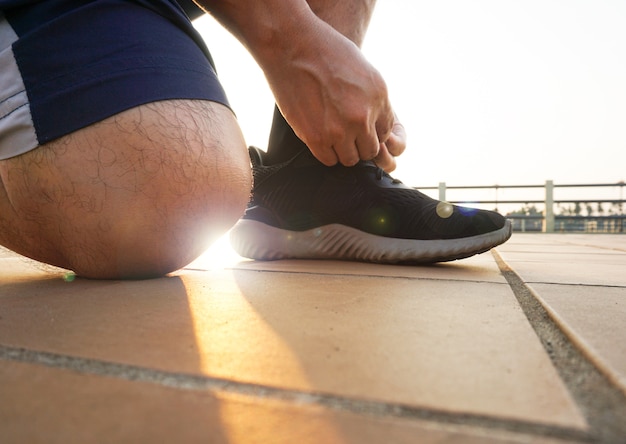 Man tying running shoes