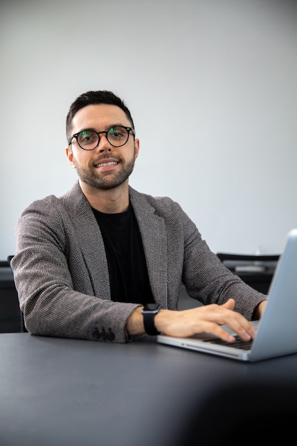 man typing on a computer, man sitting in an office answering emails