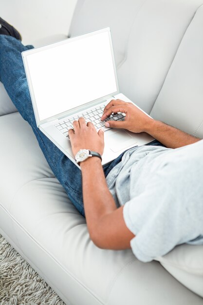 A man typing on his laptop