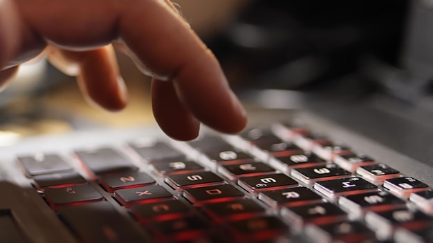 Man typing on keyboard of computer