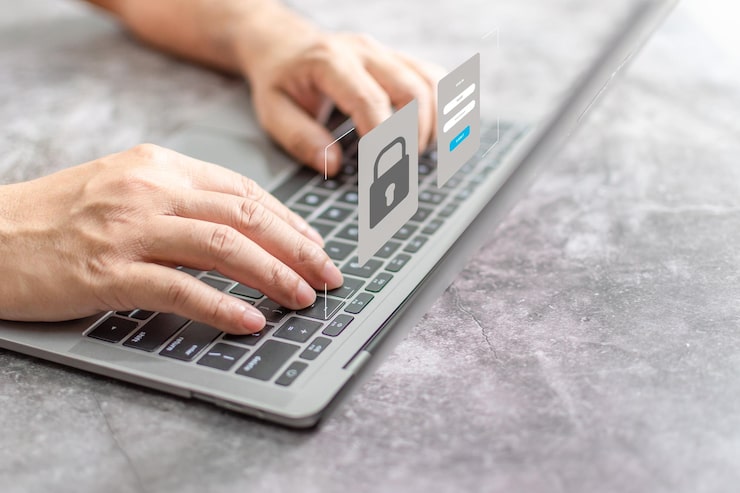 Photo man typing on keyboard to use computer network laptop screen showing login for security system concept work at home with computers and internet notebook computer on table close up blur background