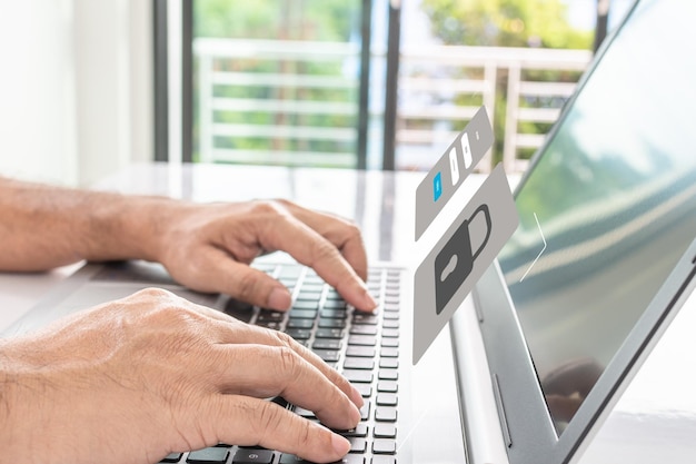 Man typing on keyboard to use computer network Laptop screen showing login for security system Concept work at home with computers and Internet Notebook computer on table close up blur backgroundxA