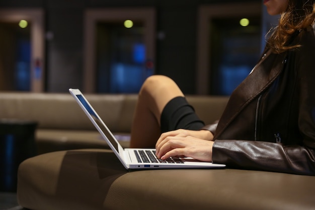 man typing on laptop in the hotel close up