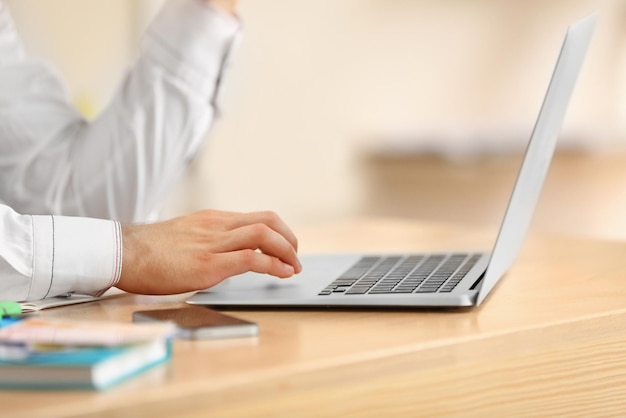 Man typing on laptop in office closeup