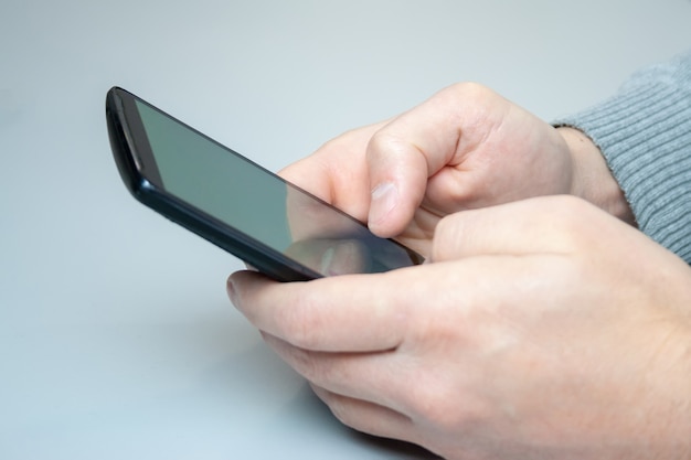 Man typing a message on his mobile phone