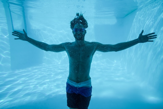 Uomo sott'acqua con le braccia aperte