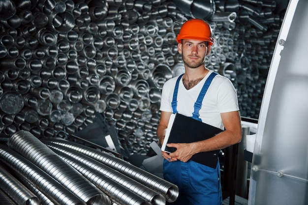 Man in uniform works on the production