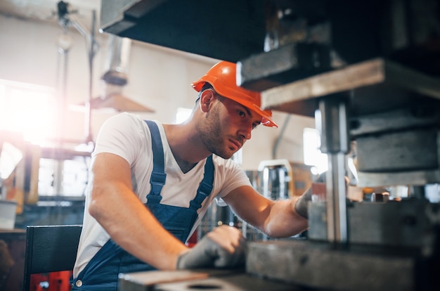 Man in uniform works on the production