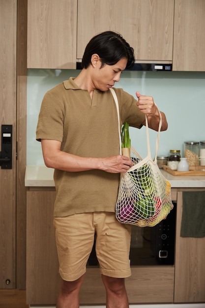 Man Unpacking Reusable Bag